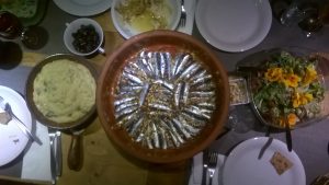 Sardines in bread coat on tomatoe, onion with rosmay and origano cooked in own liquid